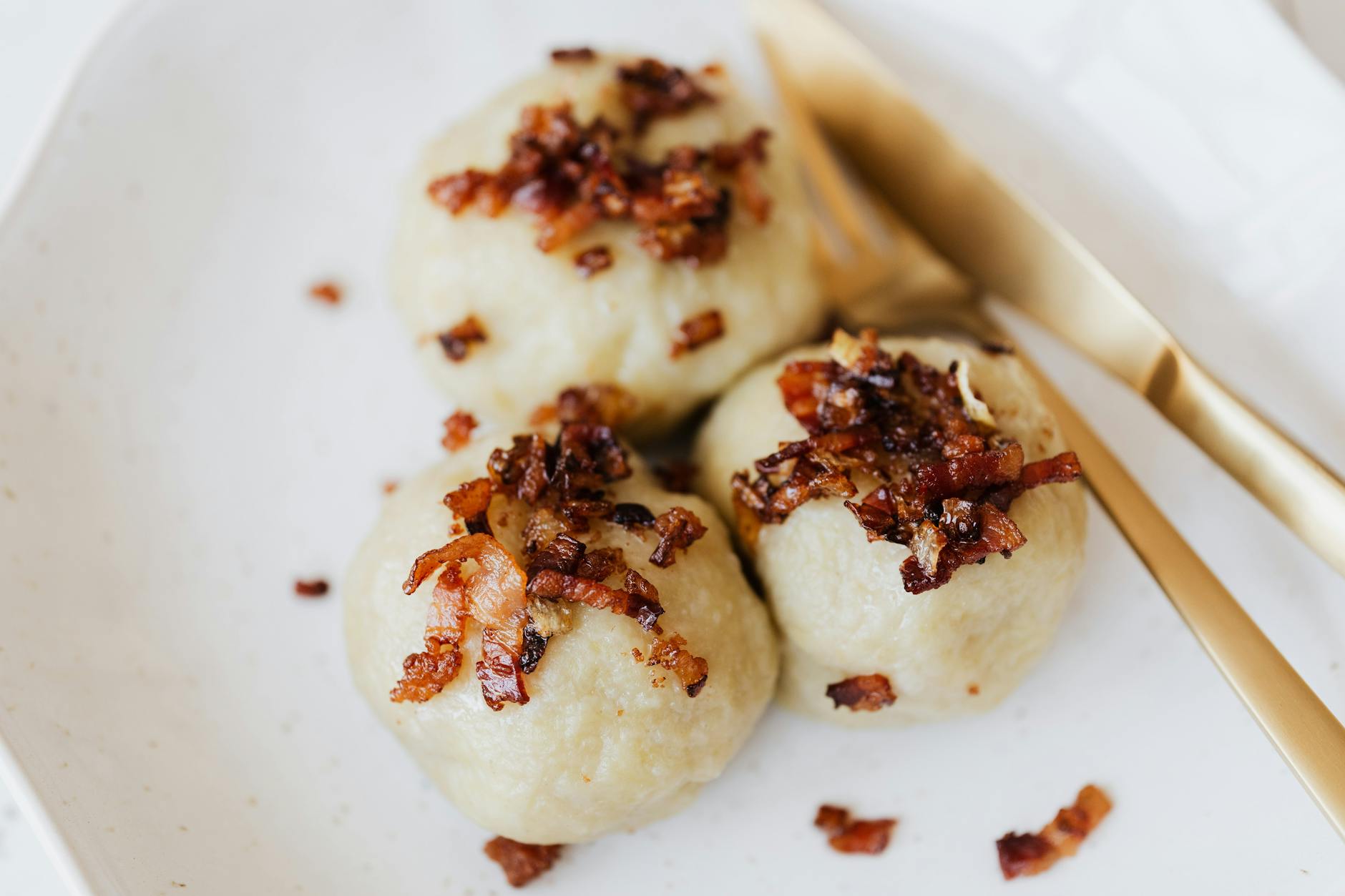 Kluski śląskie bez stresu: proporcje, które warto zapamiętać Kluski śląskie na talerzu z boczkiem jako domowy obiad